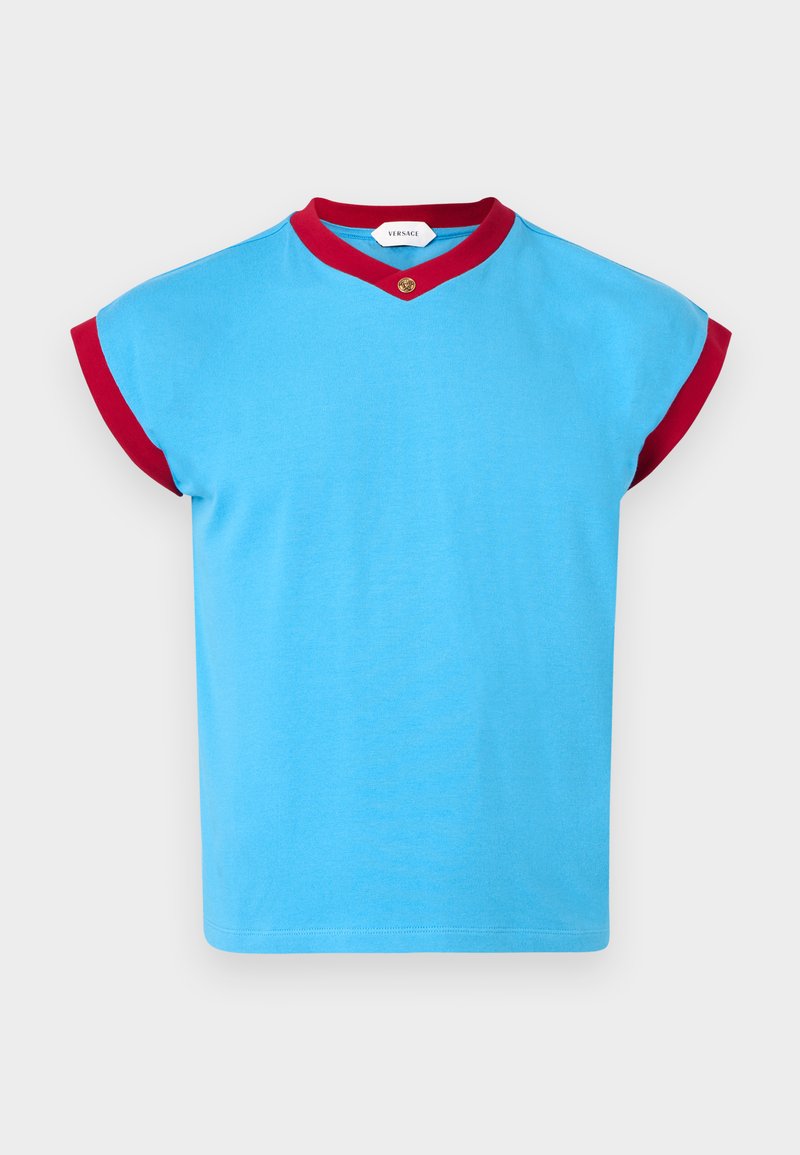 Short-sleeve blue top with red trim on sleeves and neckline, featuring a small gold button detail at the center collar.