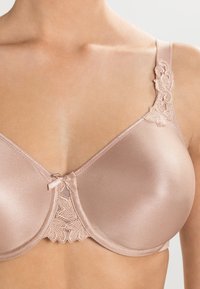 Moulded bra in soft beige satin with lace detailing on the strap and center, featuring a small bow at the base of the cups.