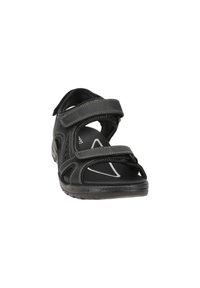 Black sandal featuring adjustable Velcro straps, open design, textured sole, and contrasting gray stitching on a smooth material.