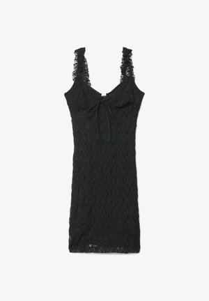 Abito nero senza maniche in pizzo con spalline arricciate e fiocco annodato sul davanti, lunghezza al ginocchio e aderente.