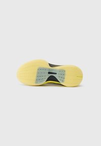 Yellow shoe sole with a textured surface featuring a herringbone pattern, accented by a dark grey section at the center.