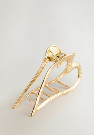 Gold metal hair claw with a textured surface, heart-shaped design, and five prongs for secure holding. Durable and decorative accessory.