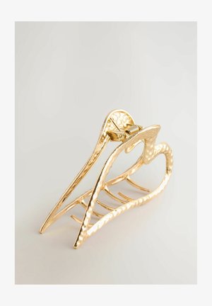 Gold metal hair claw with a textured surface, heart-shaped design, and five prongs for secure holding. Durable and decorative accessory.