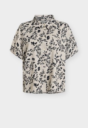 Blouse beige à manches courtes avec imprimé floral abstrait noir et boutons à l'avant, dotée d'un col classique.