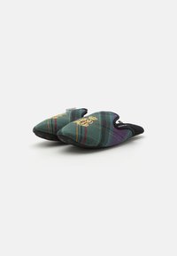 Tartan slippers in green with red and purple lines, featuring a black textured sole and an embroidered gold logo on the upper.