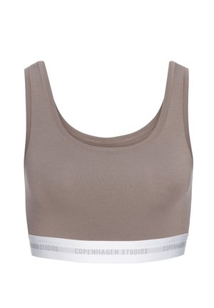 Taupe sports bra with wide straps and white elastic band at the bottom featuring "Copenhagen Studios" text.