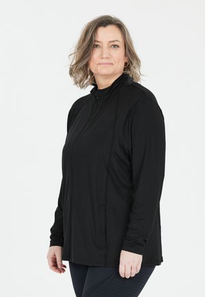 Svart långärmad jacka med hög krage, dragkedja fram och sidofickor. Tyget ser jämnt och stretchigt ut. Mjuk textur, figurnära design.
