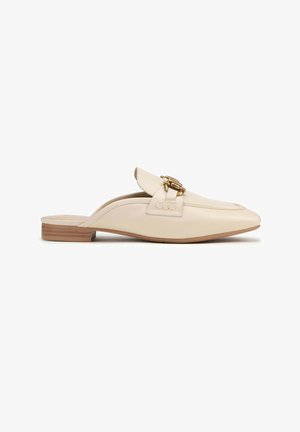 Beige leather mules with a pointed toe, decorative gold hardware, and a low wooden heel. Smooth texture with a subtle sheen.