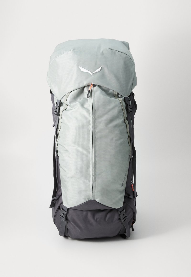 Light gray backpack with a top flap, zipper closure, and dark gray base. Features straps on the sides and a geometric texture on the fabric.
