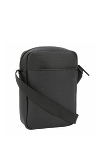 Borsa a spalla rettangolare nera, realizzata in materiale testurizzato, con una sola tracolla regolabile e una chiusura superiore con zip.
