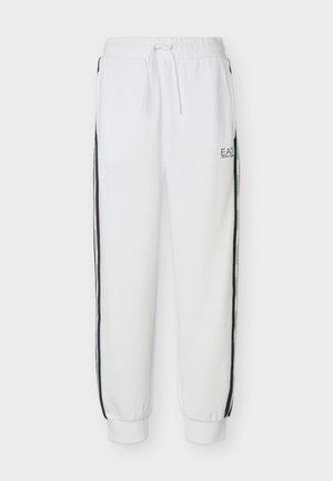 Pantalon de survêtement blanc avec poignets et taille élastiques, bandes latérales, poches avant et logo EA7 Emporio Armani sur la cuisse gauche.