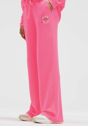 Helle pinke Jogginghose aus weichem, strukturiertem Stoff. Mit Kordelzug in der Taille und kleinem Logo auf der linken Seite. Locker geschnittenes Design.