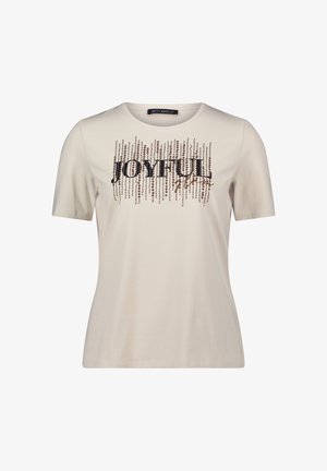 Beige kortærmet t-shirt lavet af blødt stof med et palietteret "JOYFUL" grafisk design med lodrette linjer og dekorative detaljer.