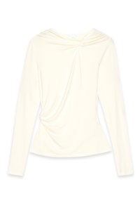 Long-sleeve cream top with a round neckline, gathered fabric across the chest, and a fitted silhouette that flares at the waist.