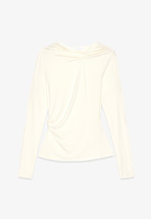 Maglietta a maniche lunghe crema con scollatura rotonda, tessuto arricciato sulla parte del torace e una silhouette aderente che si allarga in vita.