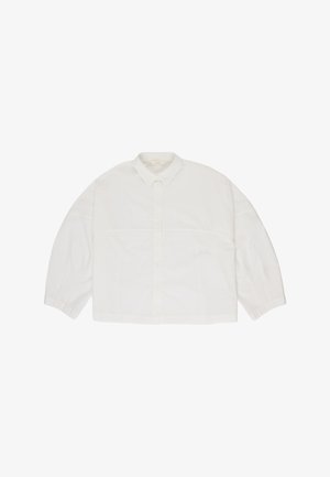 White long-sleeve button-up shirt with a classic collar and a loose, boxy fit, displayed flat on a white background.