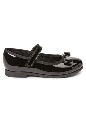 Chaussure plate Mary Jane en cuir verni noir avec une bride unique, un bout arrondi, une semelle flexible et un nœud décoratif sur le dessus.
