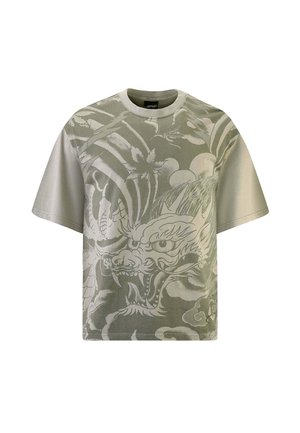 Short-sleeve t-shirt in light olive green cotton, featuring a detailed white dragon graphic and cloud motifs across the front.