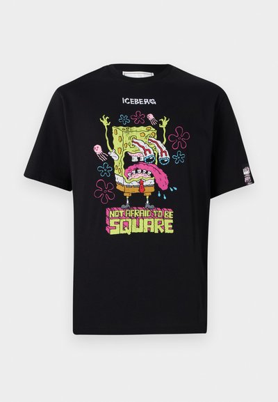 Black t-shirt featuring a colorful graphic of a character with exaggerated features, slogan "NOT AFRAID TO BE SQUARE," and jellyfish accents.
