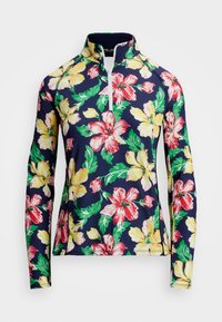 Camisa de manga larga con estampado floral sobre fondo marino, con grandes patrones de hibiscos rojos, rosas y amarillos, un cuello con cremallera de cuarto y tela elástica.