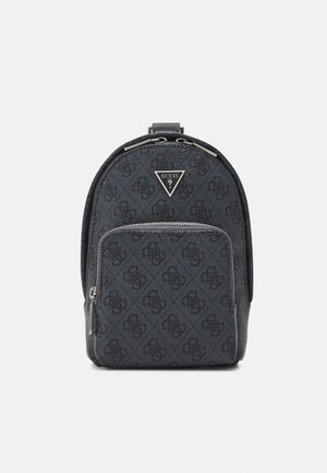 Backpack with a dark blue textured fabric featuring a subtle logo pattern. Silver hardware accents and a triangular logo patch on the front.