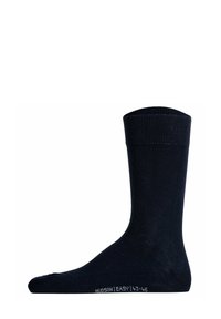 Marineblaue Baumwollsocke mit geripptem Bündchen, glatter Textur und weißem, bedrucktem Markenetikett auf der Sohle. Standard Design in mittlerer Länge.