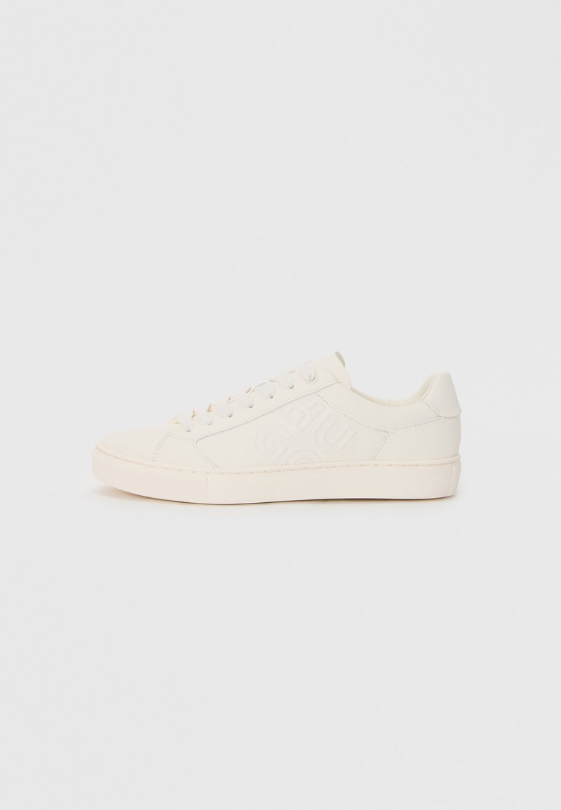 Sneaker realizzati in pelle color crema con design del logo in rilievo, punta rotonda, suola piatta e sei asole per i lacci.