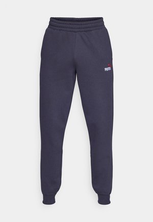 Laivastonsiniset collegehousut, joissa on ribbineulottu vyötärönauha, kapenevat hihansuut ja vasemman reiden valkoinen, kontrastoiva Puma-logo. Sileä kangaspinta.