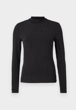 Black long-sleeve turtleneck made from stretchy fabric, featuring white polka dots evenly distributed across the surface.