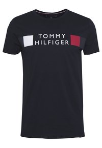 Black short-sleeve crew neck T-shirt with "Tommy Hilfiger" text and red, white, and navy blue color blocks across the chest.