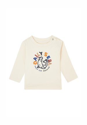 Cremefarbiges Langarmshirt mit einem Cartoon-Segelbauchgrafik in Blau und Orange, mit dem Text "TÄGLICHER SEAL NUR FÜR NOPPIES." Aus weichem Baumwollmaterial.