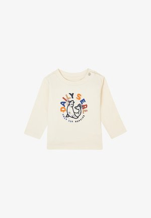 Crème kleurige langetermijn shirt met een cartoon robbe grafiek in blauw en oranje, met de tekst "DAILY SEAL ONLY FOR NOPPIES." Zachte katoenen stof.