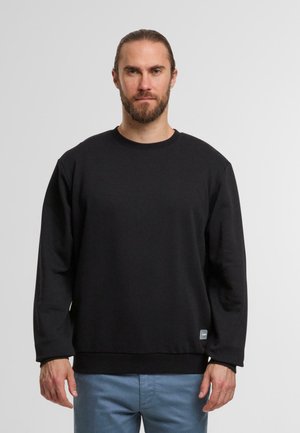 Zwarte sweatshirt met een ronde halslijn en lange mouwen. Gemaakt van een gladde stof, met een geribde zoom en een klein logootje aan de onderkant.