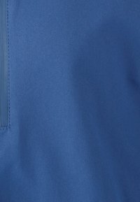 Tejido azul con una textura suave, que presenta un brillo sutil. Incluye un panel vertical brillante azul para un detalle adicional. Adecuado para diversas prendas.