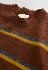 Brown knitted sweater with ribbed crew neck, featuring gray and yellow horizontal stripes. Soft texture and label visible near the collar.