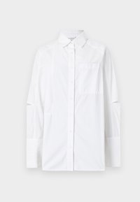 White button-up shirt featuring long sleeves with cut-out details, a chest pocket, and a structured collar. Made from a lightweight fabric.