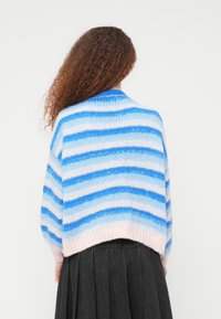 Ριγέ πλεκτό πουλόβερ σε ανοιχτό μπλε, σκούρο μπλε και ροζ. Κοντό σχέδιο με φαρδιά μανίκια και απαλό, υφασμάτινο ύφασμα.