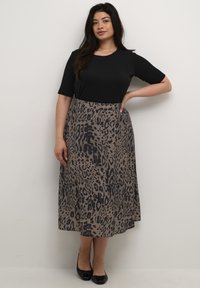 Black short-sleeve top paired with a long, brown skirt featuring a black leopard print pattern. Simple design, smooth texture, and knee-length.