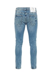 Jean skinny bleu clair avec un effet délavé, design à cinq poches, et coutures visibles. Étiquette attachée à la ceinture.