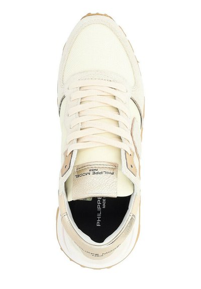 Cream-colored sneaker with textured canvas and leather accents, featuring a lace-up closure, rubber sole, and branded insole.