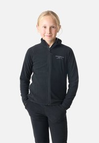 Giacca in pile nera con zip frontale, colletto alto e dettaglio del logo. Caratterizzata da maniche lunghe e una morbida texture abbinata a pantaloni coordinati.