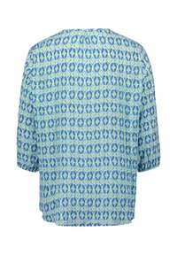 T-shirt à manches courtes avec un motif géométrique en bleu clair et vert, fabriqué dans un tissu léger, avec une coupe décontractée et un ourlet arrondi.