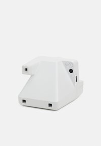 White camera device with a geometric design features ports, a power button, and a glossy surface. Angled shape allows for stability.