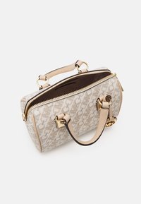 Borsa a tracolla beige con texture, con una zip dorata, manici in pelle doppia e un esterno decorato. Presenta un interno marrone con una tasca.