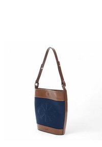 Blue canvas shoulder bag with brown leather accents, featuring a front embossed design and adjustable strap. Simple rectangular shape.