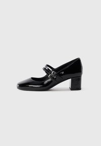 Black patent leather Mary Jane shoe with two buckle straps and a low block heel on a white background.