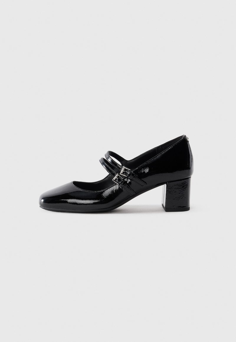 Black patent leather Mary Jane shoe with two buckle straps and a low block heel on a white background.