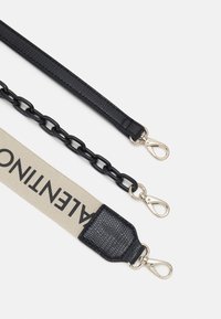Black chain strap featuring woven texture, a beige fabric section with printed letters, and silver-tone metal clasps for attachment.