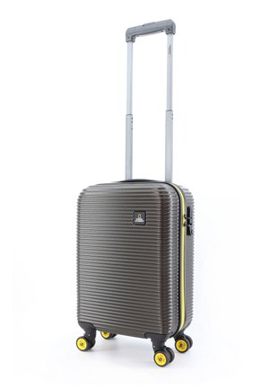 Hard-shell carry-on suitcase in dark gray with a ribbed texture, yellow wheels, and a yellow zipper accent. Features a retractable handle.
