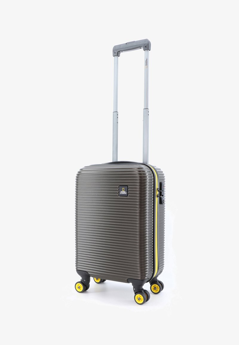 Hard-shell carry-on suitcase in dark gray with a ribbed texture, yellow wheels, and a yellow zipper accent. Features a retractable handle.